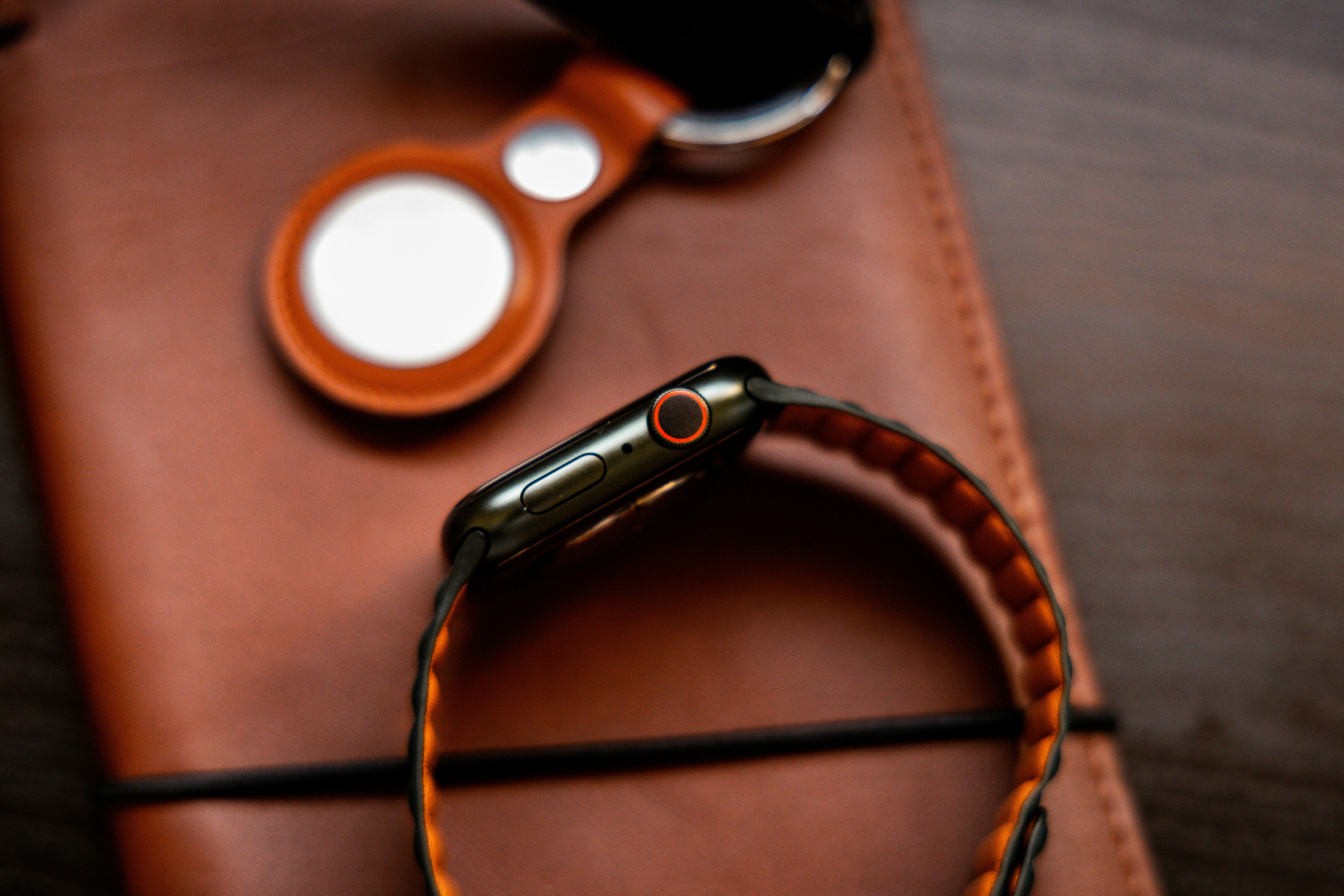 a cell phone sitting on top of a brown case